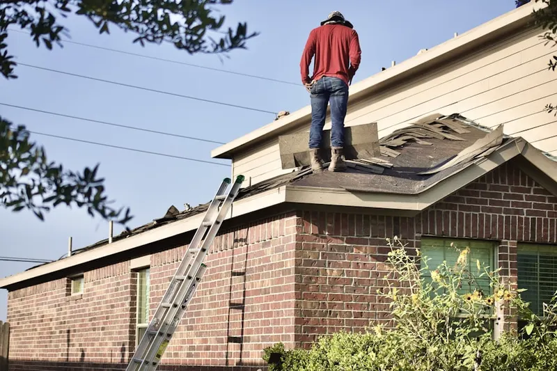 Professional roofer working on a residential roof in Northview